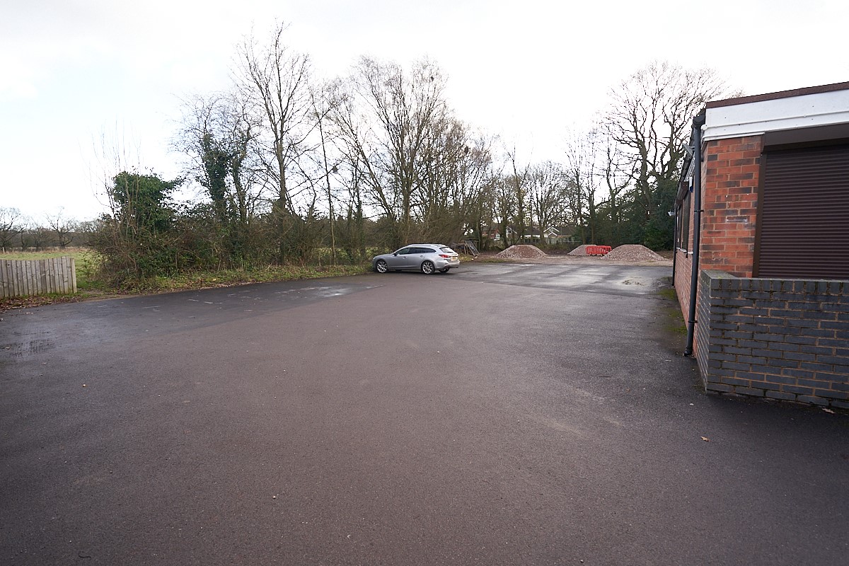 Large floodlit car park at rear